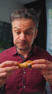 Junk food advertisement concept. Man eating fried chicken, enjoying fast food.