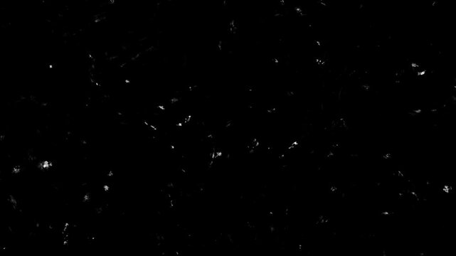 Tiny white particles floating gently in dark void with subtle cinematic motion