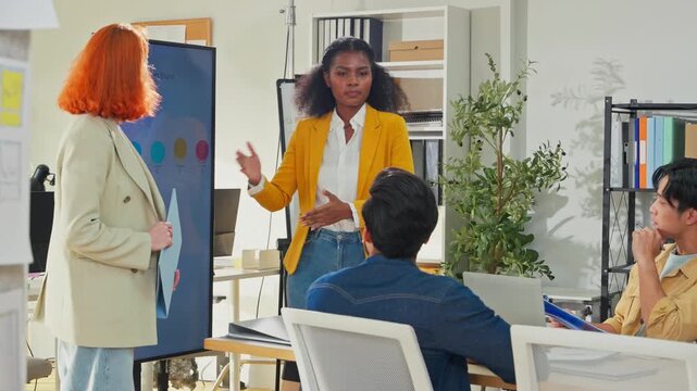 Diverse multiracial business team brainstorming in open modern office using AI bot to analyze and summarize client data, focused analysts presenting strategic plan, future of work concept