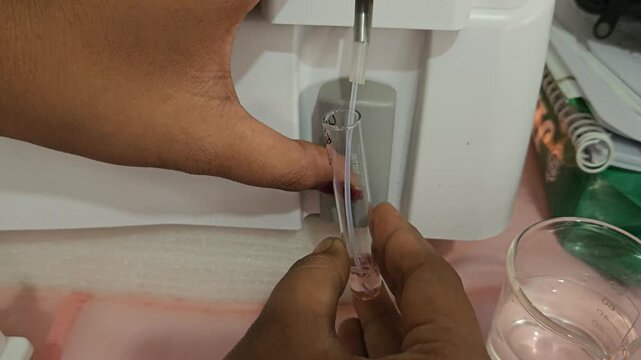 Laboratory Technician Preparing Clinical Samples with Micropipette in Modern Medical Laboratory