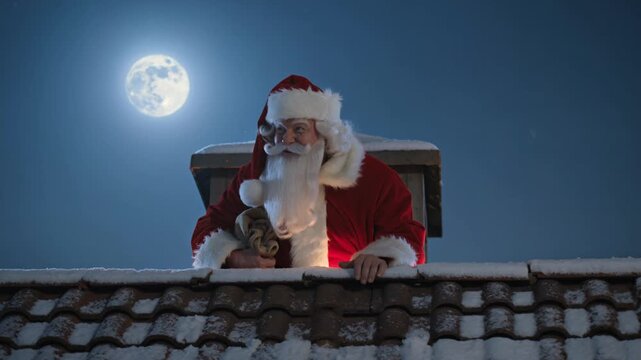 Santa Claus peeking from a snowy rooftop chimney at night under full moon