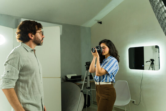 Photographer taking headshot of actor auditioning in studio for casting session, discussing role