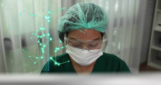 Professional Asian female doctor wearing protective scrubs, mask, and goggles works with advanced digital data network graphics, Advancing Research and Treatment concept