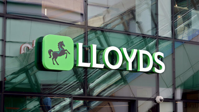 Manchester, England, UK - 18 June 2026: Lloyds Bank sign, corporate logo, financial institution storefront signage on glass building facade with green horse emblem