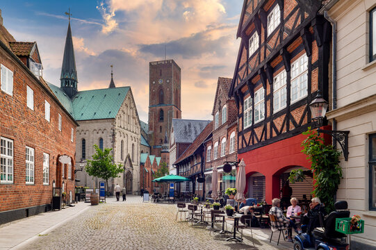 Ribe, Denmark, view of the cathedral along a historic old town street with half-timbered houses and brick architecture at sunset