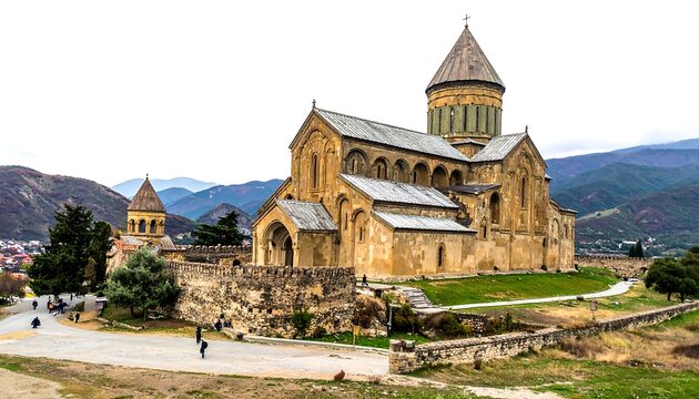Historic stone church with clock tower in scenic valley.