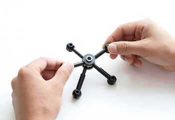 Obraz premium Hands showing the assembly of a base connector for the modular kit, illustrating the mechanical locking mechanism.