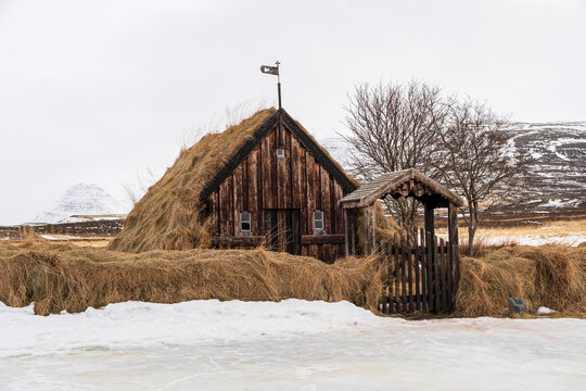 Traditional Icelandic turf church with grass roof in winter landscape