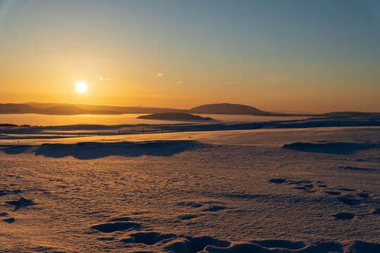 Beautiful winter sunrise over a snowy volcanic landscape and frozen lake in Iceland