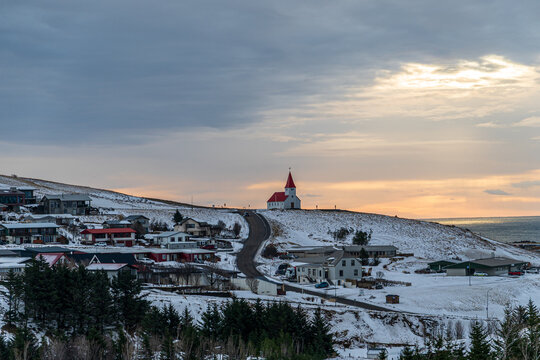 Village of V&iacute;k with church on hilltop in winter, Iceland
