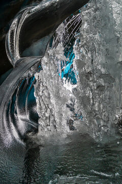 Beautiful blue ice cave interior with skylight hole opening to the sky in Vatnaj&ouml;kull National Park, Iceland