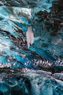 Beautiful blue ice cave interior with skylight hole opening to the sky in Vatnaj&ouml;kull National Park, Iceland