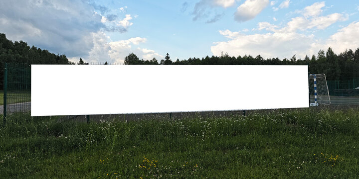 Blank white banner displaying on outdoor fence, providing copy space for advertising or general information message