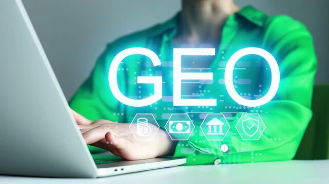 Person sits at a table using a laptop with a blue green graphic that shows the word GEO among various icons.