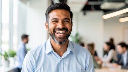 Fototapeta premium joyful diverse businessman laughing in bright modern coworking space suitable for corporate happiness marketing