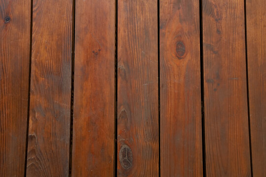 Wooden texture background showing parallel boards with natural patterns and colors taken indoors during daytime