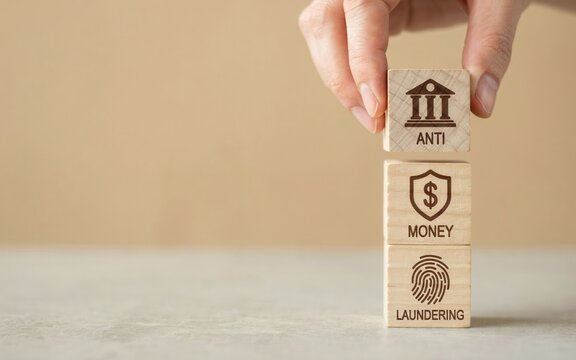 Hand stacking wooden blocks with anti money laundering concept