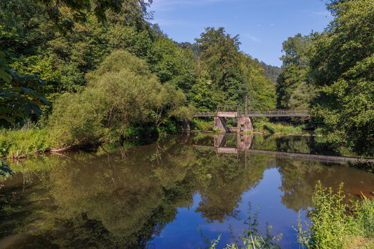 An old wooden bridge over the Nagold River in the summer