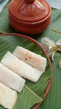Pouring Syrup over Traditional Dessert on Banana Leaf