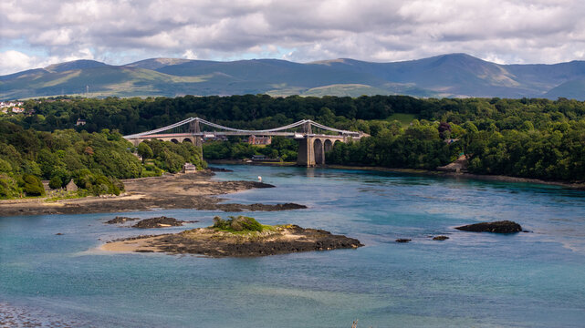 Aerial Photo Menai Suspension Bridge. The Menai Suspension Bridge (Welsh: Pont y Borth or Pont Grog y Borth) is a suspension bridge spanning the Menai Strait between the island of Anglesey 