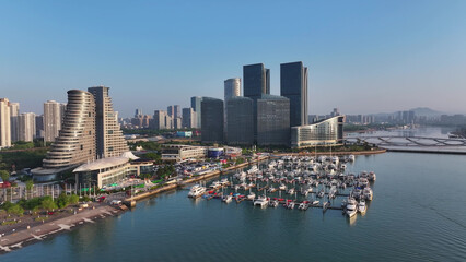 Modern port cityscape of Rizhao Shandong featuring marina yachts high-rise buildings and waterfront development © zhu difeng