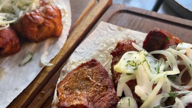 Delicious pork shashlik. Grilled meat, pieces with onions and dill. Caucasian barbecue.