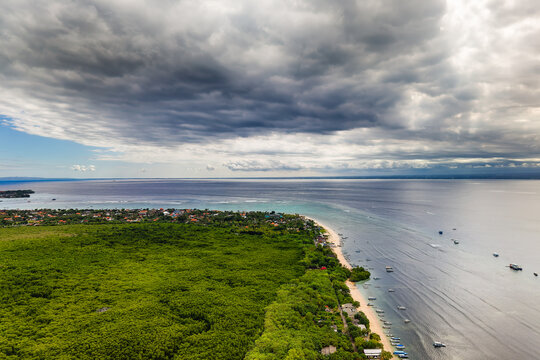Dramatic storm clouds over tropical beach and mangroves in Nusa Lembongan