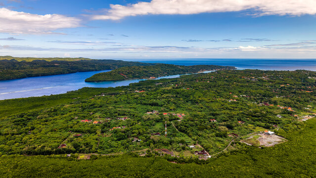 Scenic drone panorama of Ceningan island channel and tropical vegetation in Bali