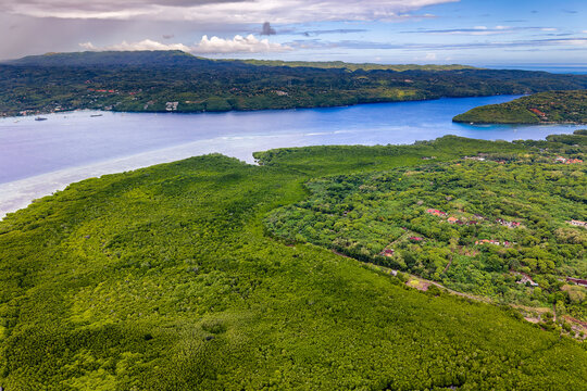 Aerial view of lush green mangrove forest and turquoise channel in Nusa Lembongan
