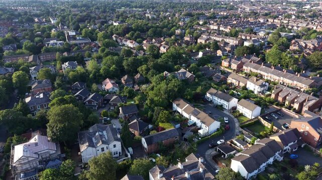 Aerial drone 4K scene showing rooftops reflecting warm golden hour light across the estate England