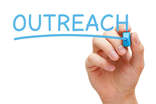Hand Writing The Word Outreach With Blue Marker