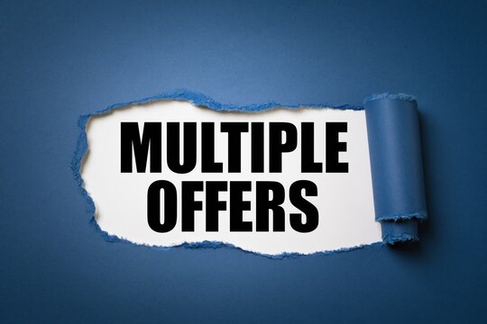 Multiple offers written on white paper revealed by torn dark blue paper