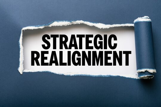 Strategic realignment text written under a torn dark blue paper edge