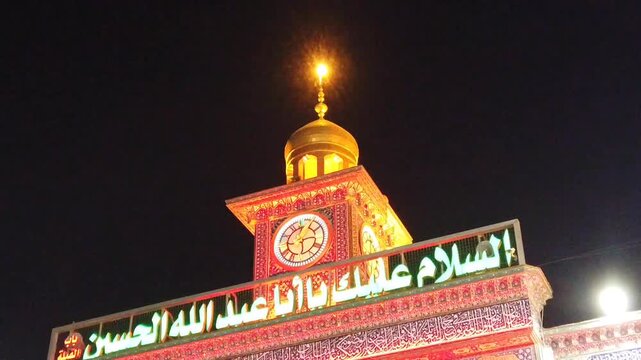 Imam Husayn Shrine Illuminated with
Red Lights and Islamic Calligraphy on
Ashura Night in Karbala