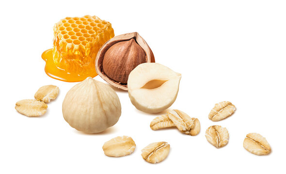 Honeycomb, hazelnut and oat flakes isolated on white background. Honey and nut cereal. Real photography