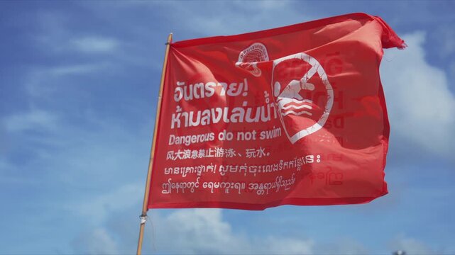 4K Slow motion POV of red warning flag at beach prohibiting swimming