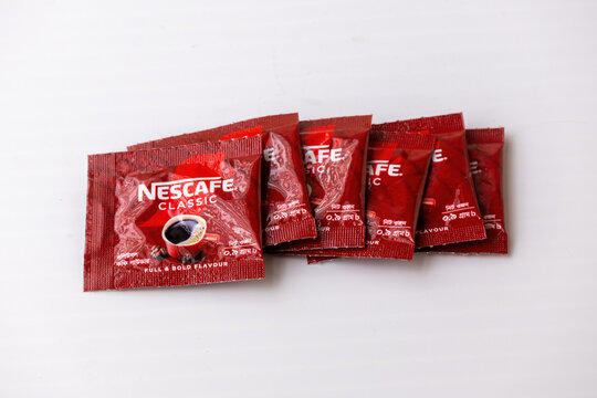 Kishoreganj, Bangladesh - 25 June, 2026 - A row of Nescafe Classic instant coffee mini plastic pouches. Global beverage manufacturing brands for budget shopping and consumer spending concepts.