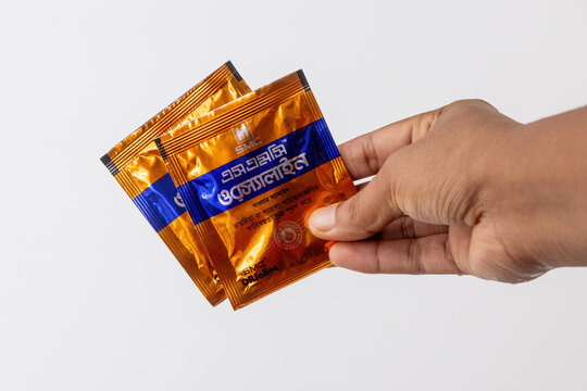 Kishoreganj, Bangladesh - 25 June, 2026 - Hand showing SMC ORSaline packages. Popular consumer pharmaceutical products and emergency first aid medical supplies in South Asia for health campaigns.