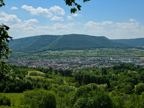 germany, picturesque dettingen an der erms church and colorful town panorama surrounded by flourishing green valley near metzingen in summer