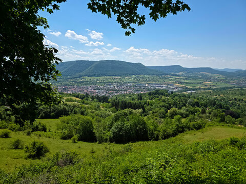 germany, wonderful panoramic view across dettingen an der erms nestled in lush green valley near metzingen beneath vibrant summer sky