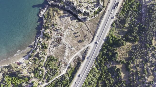 Aerial Drone View of Korykos Castle and Mediterranean Coastline in Mersin, Turkey, Historic Fortress by the Sea at Sunset