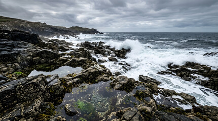 Fototapeta premium Rocky shore in a dramatic coastal landscape with waves and stones.