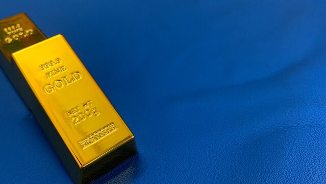 gold bar positioned on blue background, purpose for marketing or background