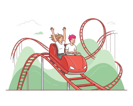 Happy young couple riding a roller coaster at an amusement park.