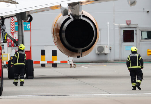 Glasgow Scotland 13th of August 2025. Airport fire crew responding near airplane jet engineFirefighters responding to an emergency incident involving an airplane at glasgow airport