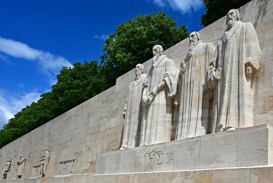 Geneva, Switzerland, Europe - 05.2026 : Prominent reformers statues - Jean Calvin, Guillaume Farel, Th&eacute;odore de Beze and John Knox, reformation wall in Bastions park, Swiss towns coats of arms 