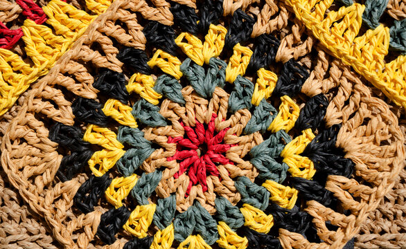 A colorful raffia granny square. A close-up of the texture of the raffia knit.