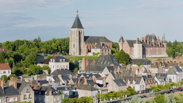 Aerial panoramic footage of the picturesque town of Gien in central France, showcasing the historic stone bridge crossing the Loire River, charming old town architecture with traditional rooftops