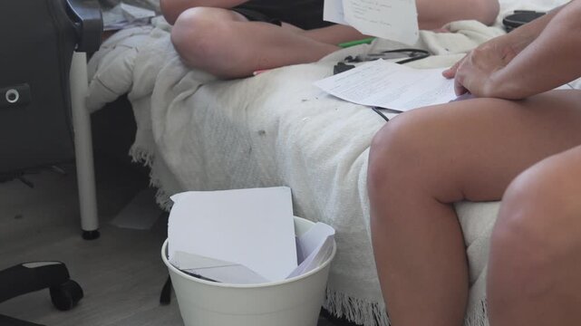 Mom and son sort through old school papers and throw the excess in the trash