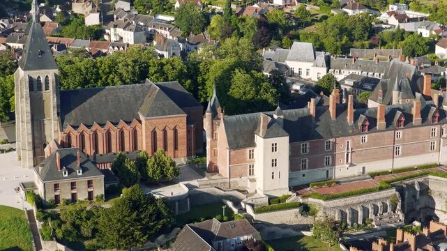 Stunning aerial footage showcasing the Chateau de Gien and the historic town center of Gien, France. The video captures the iconic Renaissance castle, surrounding medieval architecture, and